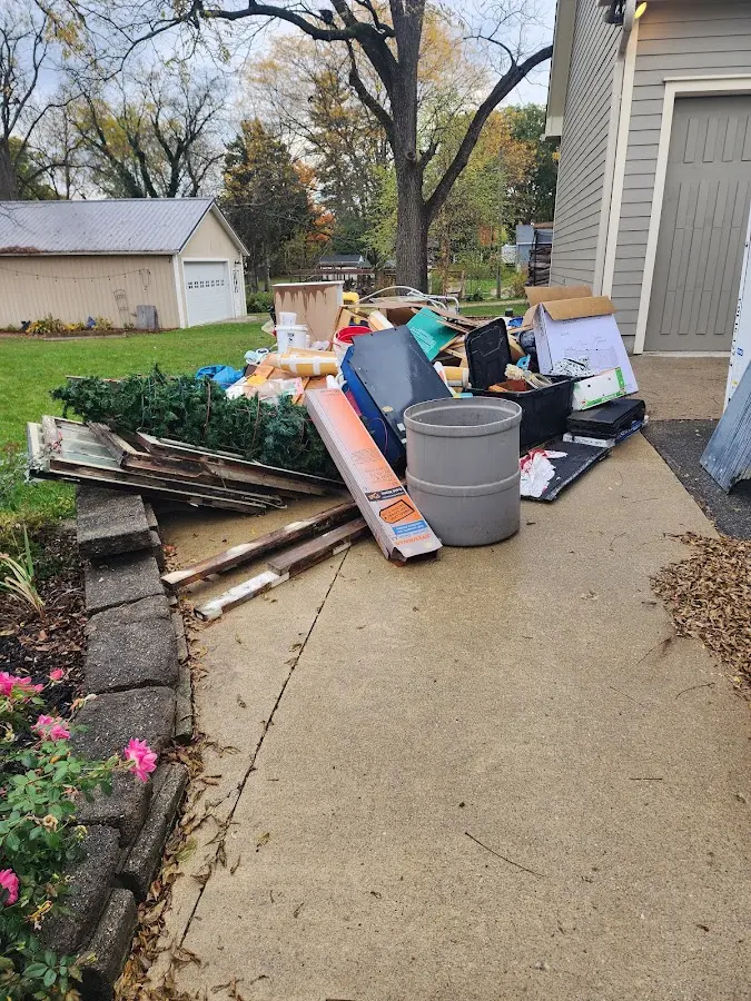 Dumpster being loaded with debris for Estate Cleanout Dumpster Rental in Redland